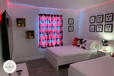 a bedroom with a bed and a pink curtain at NEW! House in Resort Waterpark Disney Orlando 2693 in Kissimmee