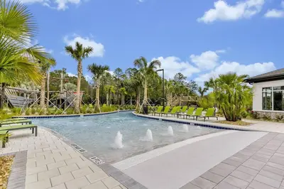a swimming pool with swans in the water at NEW Themed 10B VillaPoolSpa in Kissimmee