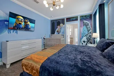 a bedroom with a large bed with a blue wall at NEW Themed 10B VillaPoolSpa in Kissimmee