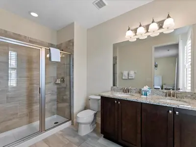 a bathroom with a shower and a toilet and a sink at Family Friendly Home With Private Pool, Game Room, Waterpark & Resort Access Near Disney At Encore Resort - 7638Wi in Kissimmee