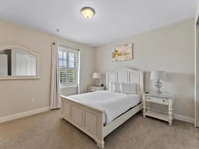a white bedroom with a white bed and a window at Family Friendly Home With Private Pool, Game Room, Waterpark & Resort Access Near Disney At Encore Resort - 7638Wi in Kissimmee