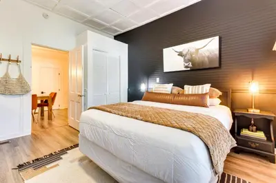 a bedroom with a large bed with a black wall at Fire Pit and Yard Updated Winter Garden Home! in Orlando