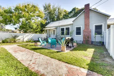a backyard with a house and a patio at Fire Pit and Yard Updated Winter Garden Home! in Orlando