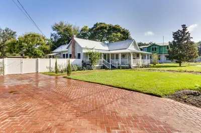 a brick driveway in front of a white house at Fire Pit and Yard Updated Winter Garden Home! in Orlando