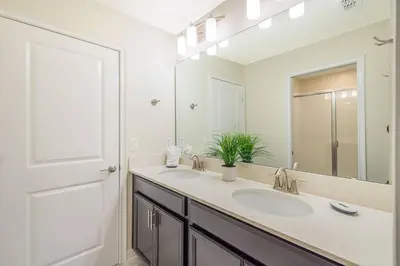 a bathroom with a sink and a mirror at Luxury Villa inside Storey Lake, Kissimmee - No Extra Fees in Kissimmee