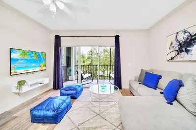 a living room with a couch and a table at 2BR Queen bed Condo - Pool - Near Disney in Orlando
