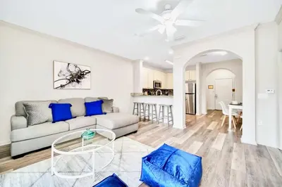 a living room with a couch and a table at 2BR Queen bed Condo - Pool - Near Disney in Orlando