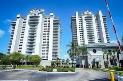 two large white apartment buildings with a street in front at Aparment 2nd floor 5 minutes from Disney in Orlando