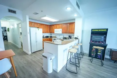 a kitchen with a counter and stools in it at Orlando Apt 9th Floor 5 min from Disney in Orlando
