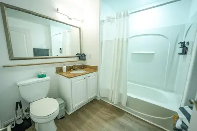 a bathroom with a toilet and a sink and a shower at Orlando Apt 9th Floor 5 min from Disney in Orlando