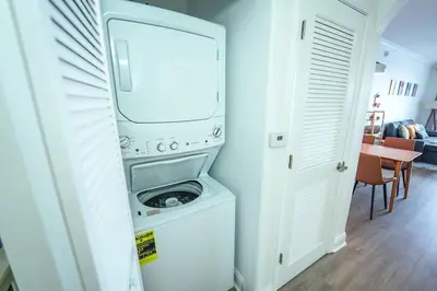 a washer and dryer in a room with a kitchen at Orlando Apt 10th floor 5 min from Disney in Orlando