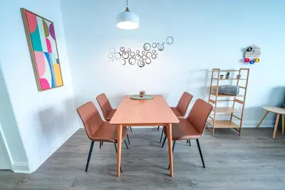 a dining room with a wooden table and chairs at Orlando Apt 10th floor 5 min from Disney in Orlando