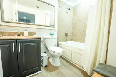a bathroom with a toilet and a sink and a bath tub at Apartment 5 min away from Disney 1st Floor in Orlando