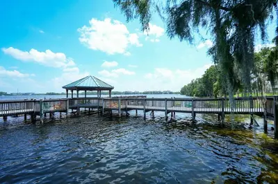 a pier with a gazebo in the water at Apt Orlando 11th Floor 5 min from Disney in Orlando