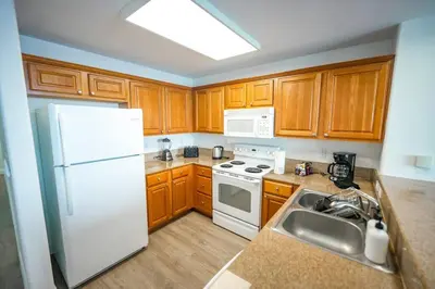 a kitchen with a white refrigerator and a sink at Apt Orlando 11th floor 5 minutes from Disney in Orlando