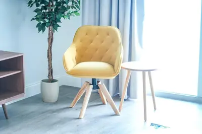 a yellow chair and a table in a room at Apt Orlando 11th floor 5 minutes from Disney in Orlando
