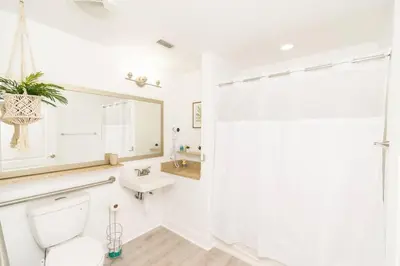 a bathroom with a toilet and a sink and a mirror at Orlando Blue Heron condo 1 mile from Disney in Orlando