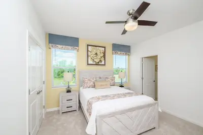 a bedroom with a bed and a ceiling fan at 15BR Mansion Near Disney Private Pool Hot Tub in Kissimmee