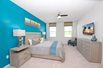 a bedroom with a bed and a blue wall at 15BR Mansion Near Disney Private Pool Hot Tub in Kissimmee