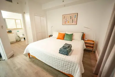 a bedroom with a large white bed with orange and green pillows at Renovated Condo Blue Heron 5 pax in Orlando