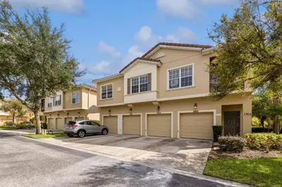 a house with a car parked in front of it at Amazing Disney Themed Oasis 3BR near Parks townhouse in Orlando