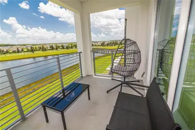 a balcony with a swing and a chair on it at The Epic Miami Supreme Storey Lake in Kissimmee