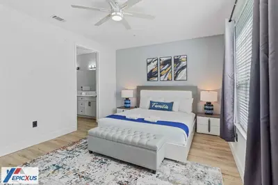 a white bedroom with a bed and a ceiling fan at The Epic Madrid Vista Cay Orlando in Orlando