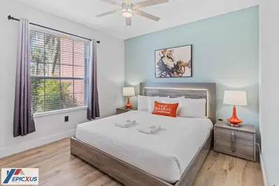 a bedroom with a large bed and a window at The Epic Madrid Vista Cay Orlando in Orlando
