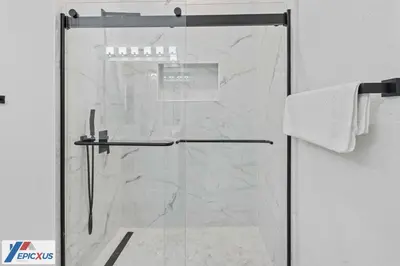 a shower with a glass door in a bathroom at The Epic Madrid Vista Cay Orlando in Orlando