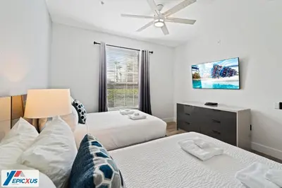 a bedroom with two beds and a ceiling fan at The Epic Madrid Vista Cay Orlando in Orlando