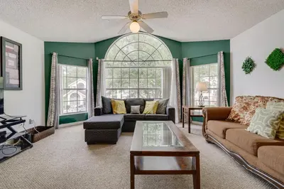 a living room with a couch and a table at 6 Mi to Disney Family-Friendly Condo in Kissimmee in Kissimmee