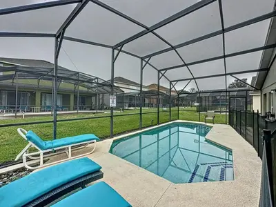 a swimming pool with a glass canopy over it at 4 BED 3 BATH IN A GATED COMMUNITY WITH POOL villa in Kissimmee