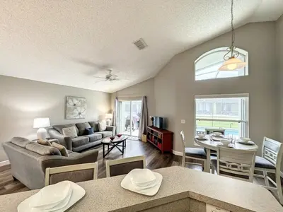 a living room with a couch and a table at 4 BED 3 BATH IN A GATED COMMUNITY WITH POOL villa in Kissimmee