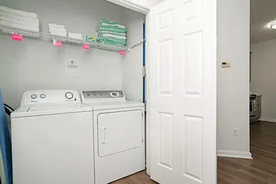 a white laundry room with a washer and dryer at Luxury Remodeled! WOW! in Orlando