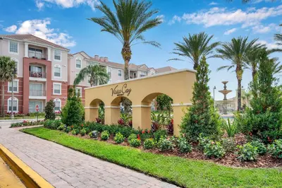 a walkway in front of a building with palm trees at Luxury Remodeled! WOW! in Orlando