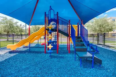 a playground with a slide and an umbrella at Luxury Remodeled! WOW! in Orlando