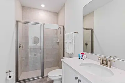 a bathroom with a shower and a sink and a toilet at 2959 Castaway Lane in Orlando