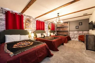 a bedroom with two beds and red curtains at Magical 9BR Villa by Disney w Pool Theme Room in Kissimmee