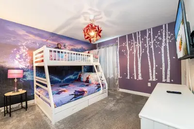 a bedroom with a bunk bed and a purple wall at Magical 9BR Villa by Disney w Pool Theme Room in Kissimmee