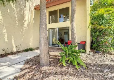 a palm tree in front of a house at Charming Lakeview Retreat III in Orlando
