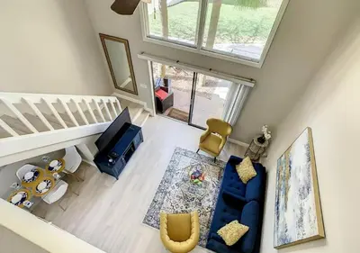 an overhead view of a living room with a blue couch at Charming Lakeview Retreat III in Orlando