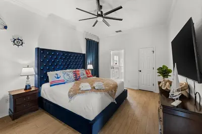 a bedroom with a bed and a ceiling fan at The Dream Vacation Home! in Orlando