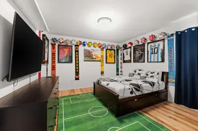 a bedroom with a bed and a flat screen tv at The Dream Vacation Home! in Orlando
