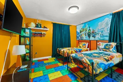 a bedroom with two beds and a tv at The Dream Vacation Home! in Orlando