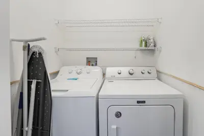 a white kitchen with a stove and a dishwasher at The Dream Vacation Home! in Orlando