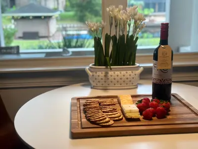 a bottle of wine and a plate of crackers and strawberries at Best of Both Worlds Lakehouse in Orlando