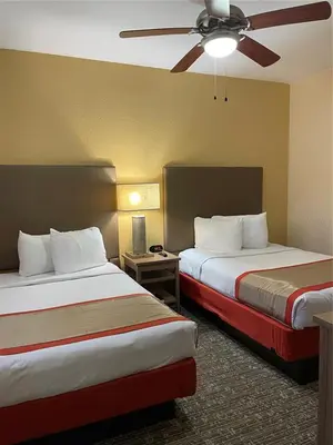 a hotel room with two beds and a ceiling fan at Floriday Resort in Orlando