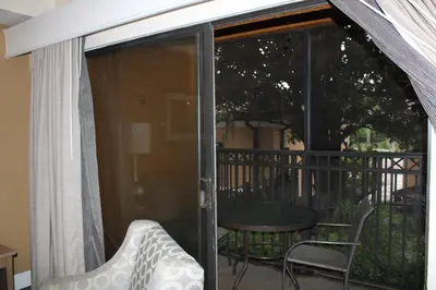 a screened in porch with a table and a chair at Floriday Resort in Orlando