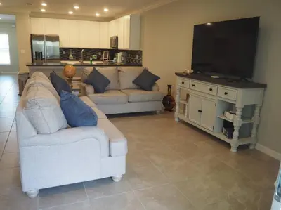a living room with a couch and a flat screen tv at Luxurious Farm Style House in Kissimmee