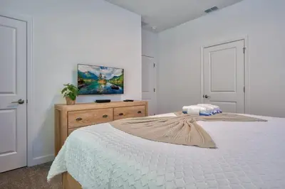 a bedroom with a bed and a painting on the wall at Ultimate Luxury Home-Private Pool Themed Bedroom in Kissimmee